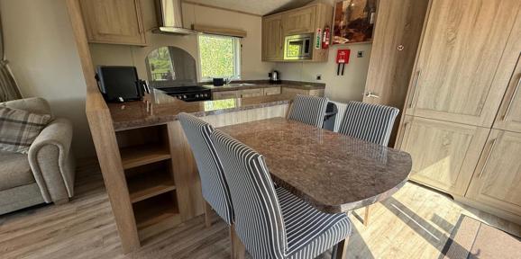 Carnaby Helmsley Lodge, dining area and kitchen at Finlake