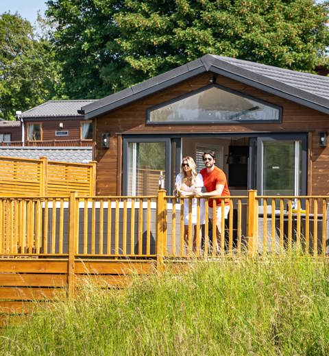 Devon Hills Couple Looking At View On Balcony