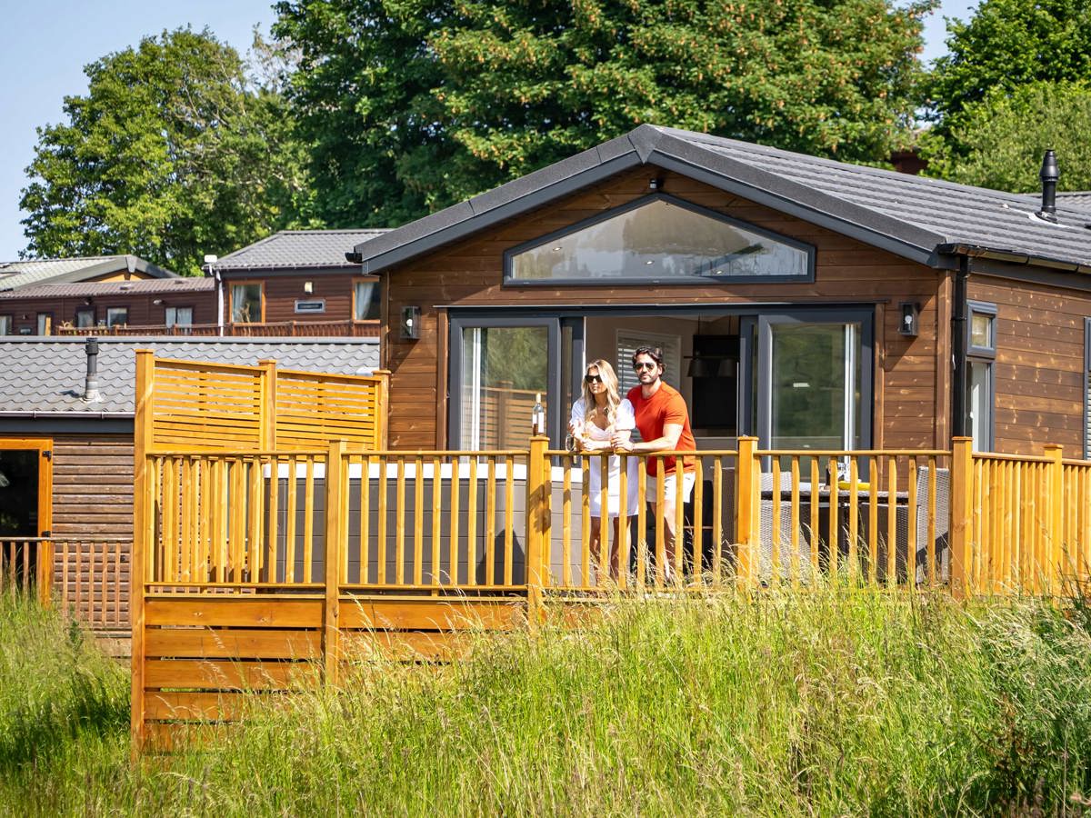 Devon Hills Couple Looking At View On Balcony