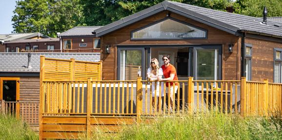 Devon Hills Couple Looking At View On Balcony