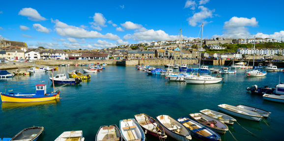 Scenic harbor site area of Porthleven, with sea side cornish house in the background near Praa Sand Holiday Park