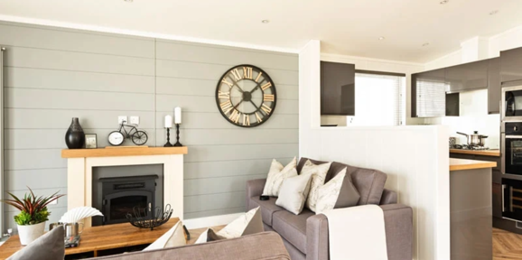 Prestige Dovecote, sofa and fireplace in lounge at Brokerswood