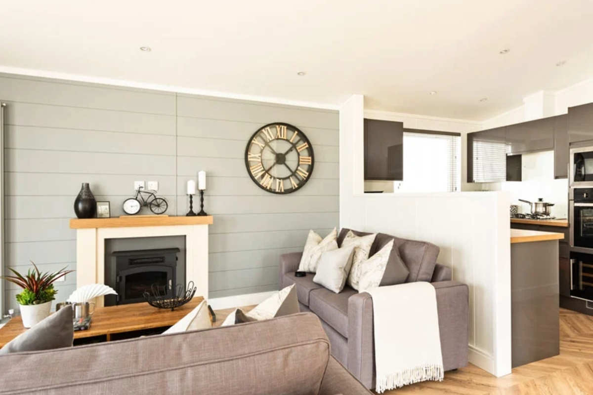 Prestige Dovecote, sofa and fireplace in lounge at Brokerswood