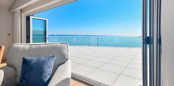 Retreat Coastal, open doors onto decking at The Warren