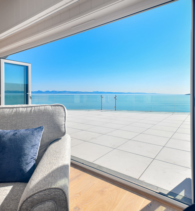 Retreat Coastal, open doors onto porcelain patio at The Warren