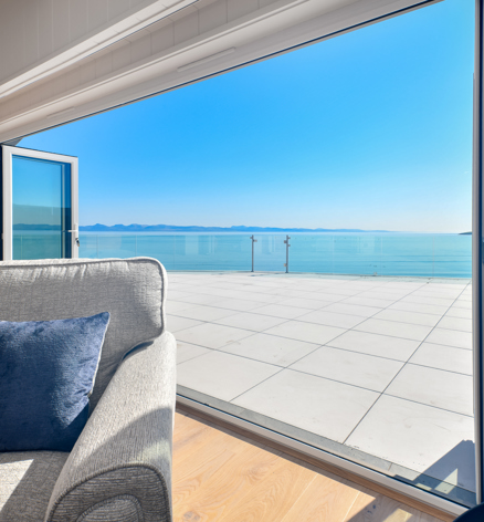Retreat Coastal, open doors onto porcelain patio at The Warren