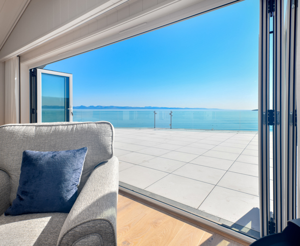 Retreat Coastal, open doors onto decking at The Warren