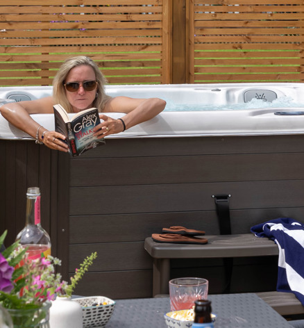 Lady reading in Hot Tub at a Dartmoor view holiday home