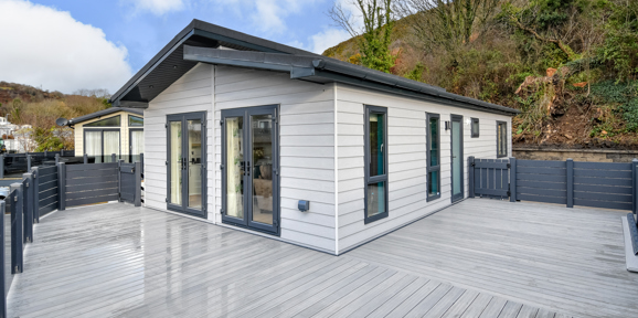 Oakgrove Shearwater, exterior with decking area and trees at TYF