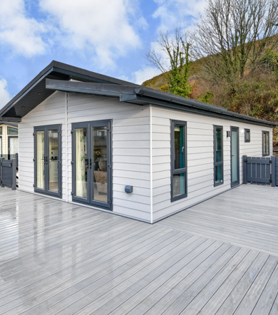 Oakgrove Shearwater, exterior with decking area and trees at TYF