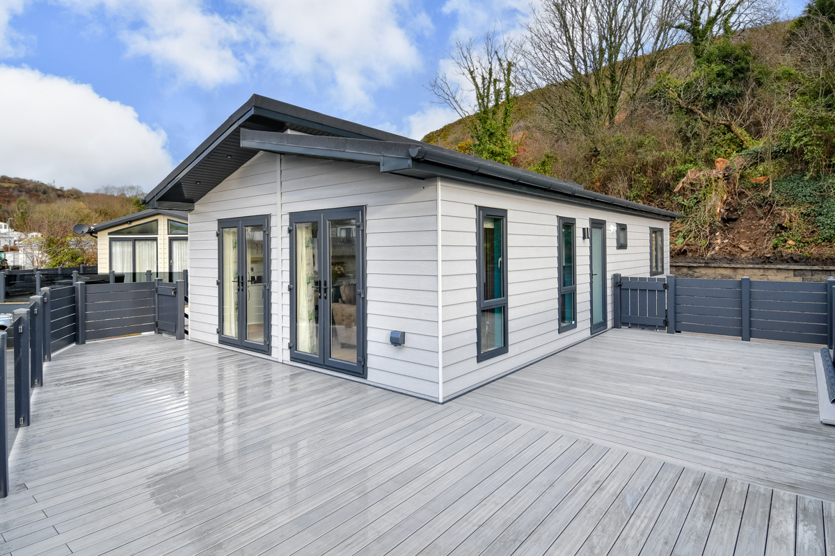 Oakgrove Shearwater, exterior with decking area and trees at TYF