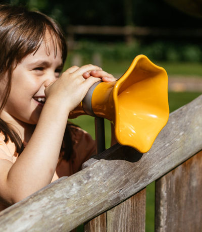 Brokerswood Girl Playing The Play Park With Noise Enhancer