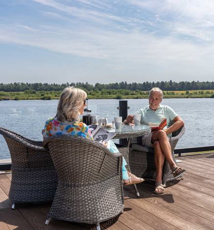 Delamere Couple Relaxing On Decking