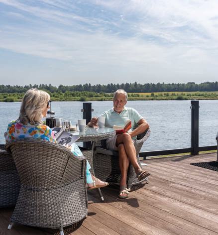 Delamere Couple Relaxing On Decking