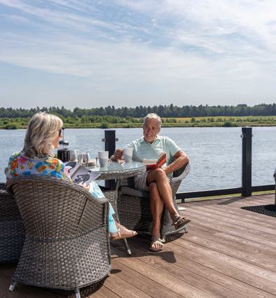Delamere Couple Relaxing On Decking