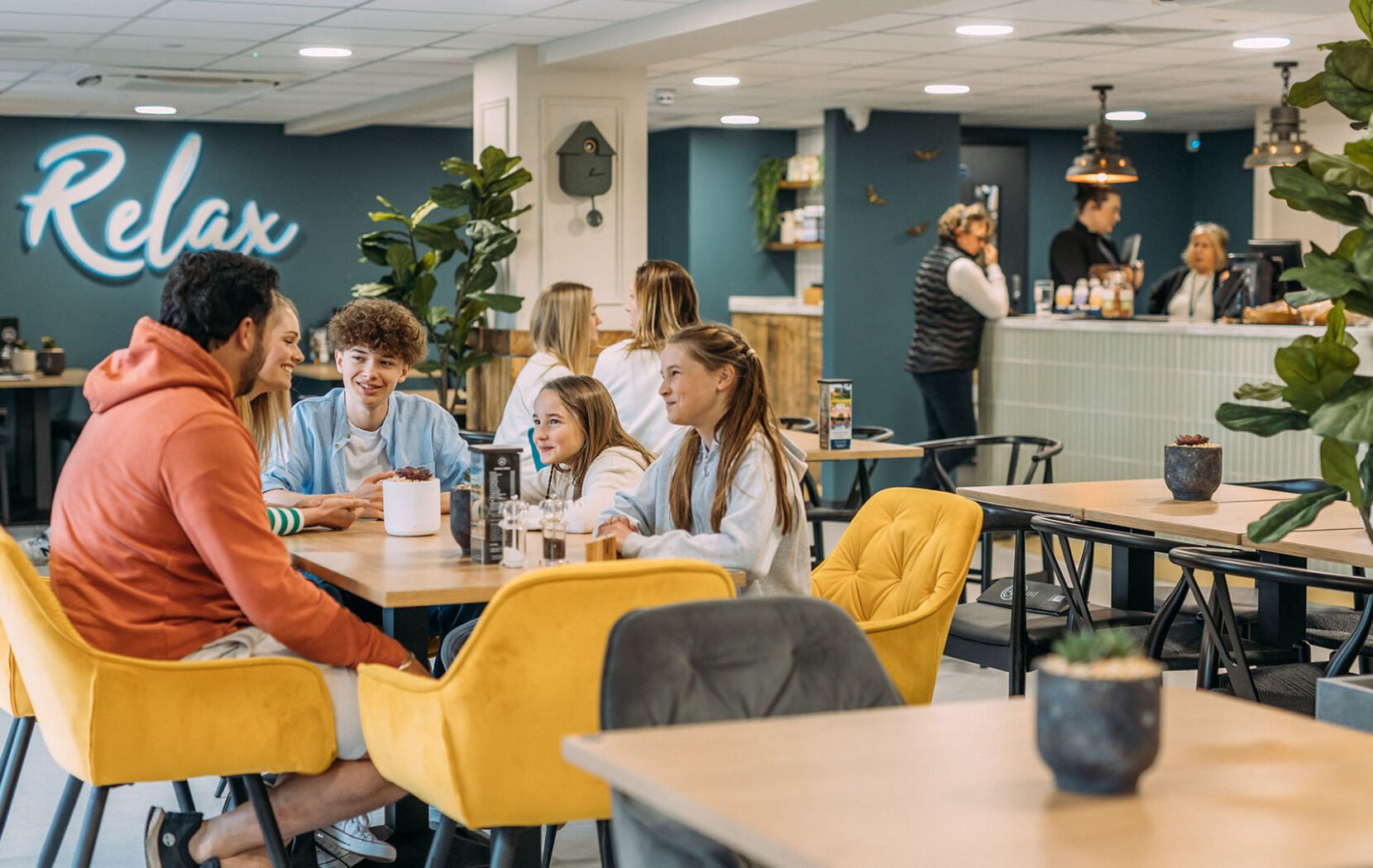 Family enjoying a meal together in a bright and modern restuarant, The Hive Cafe