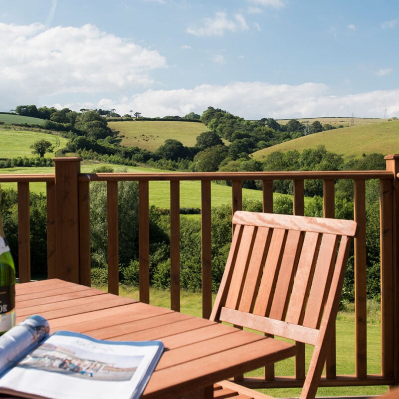 Wine glasses on a table, on a deck overlooking the Devon hills
