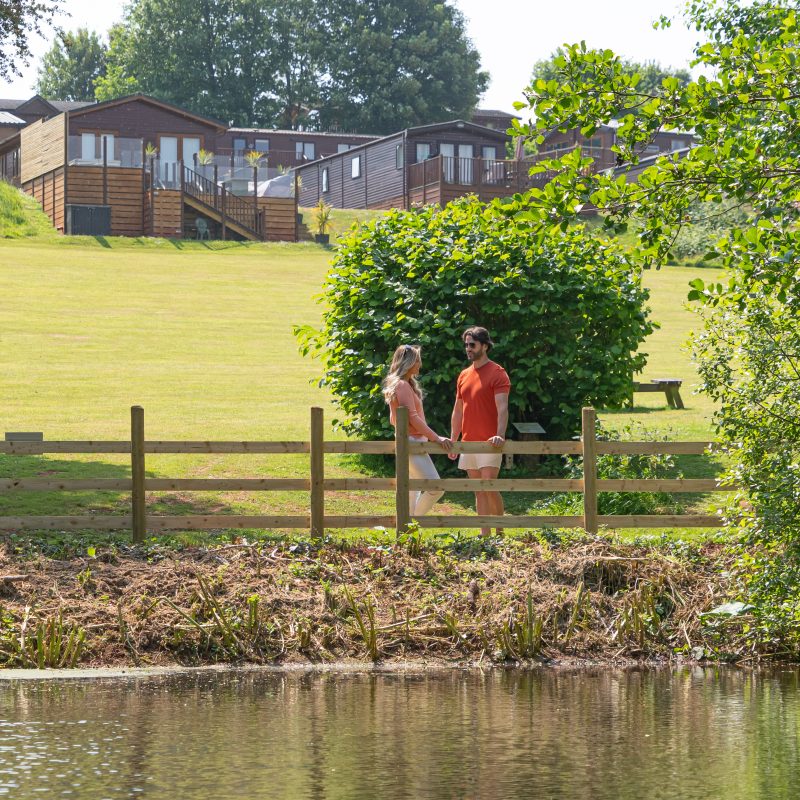 Couple standing and chatting in Devon Hills holiday park