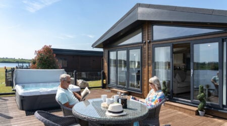 Couple enjoying the outside decking on their luxury holiday home.